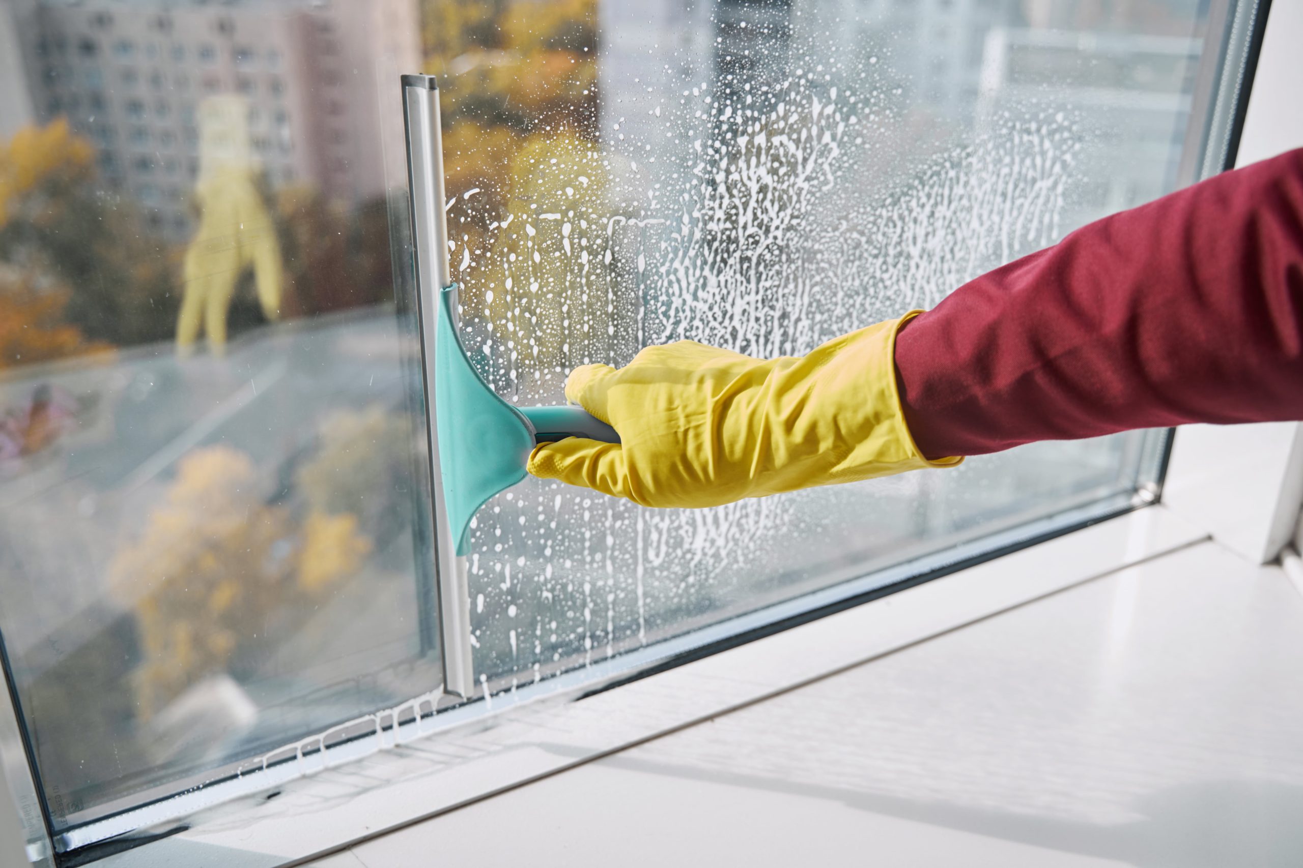 window-cleaner-washing-windowpane-using-implement-2023-11-27-04-56-38-utc-min